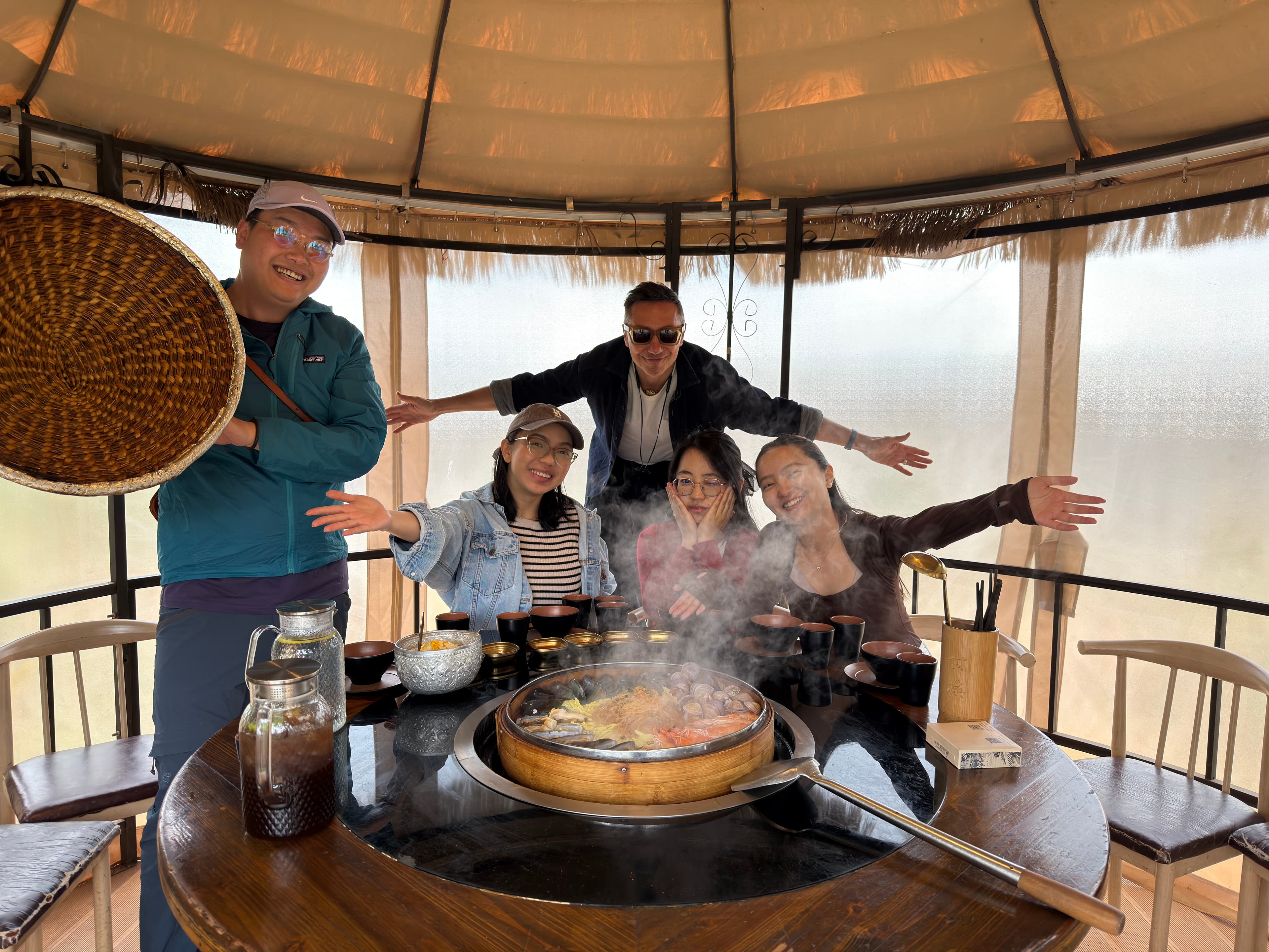 Travelers sharing a hot pot meal in a Yunnan courtyard